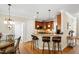 The kitchen features stainless appliances, granite countertops, and a breakfast bar overlooking dining room at 10113 San Remo Pl, Wake Forest, NC 27587