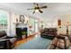 Cozy living room with fireplace, hardwood floors, and open access to dining and kitchen areas at 10113 San Remo Pl, Wake Forest, NC 27587