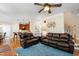 Open-concept living space with hardwood floors, ceiling fan and convenient access to the kitchen and dining area at 10113 San Remo Pl, Wake Forest, NC 27587