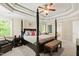 The spacious main bedroom features a tray ceiling, four-poster bed, nightstand, and carpet flooring at 10113 San Remo Pl, Wake Forest, NC 27587