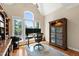 Bright home office features hardwood floors, built-in shelving, and a large window offering beautiful backyard views at 10113 San Remo Pl, Wake Forest, NC 27587