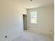 A bedroom under construction features a single window and a doorway at 102 Gobbler Dr, Smithfield, NC 27577