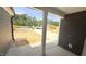 View from the covered entry shows construction and surrounding wooded area at 102 Gobbler Dr, Smithfield, NC 27577