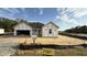 New construction home featuring a two-car garage with wrapped exterior walls at 102 Gobbler Dr, Smithfield, NC 27577