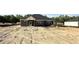 Backyard view showcasing a new home with dark siding and a well-lit backyard at 102 Gobbler Dr, Smithfield, NC 27577