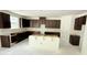 Unfinished kitchen with dark wood cabinetry and a central island, awaiting final touches at 102 Gobbler Dr, Smithfield, NC 27577
