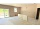 Spacious kitchen featuring sliding glass door and a window to provide natural light in an unfinished space at 102 Gobbler Dr, Smithfield, NC 27577