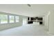 Open-concept kitchen with dark cabinets and island, adjacent to the living space, unfinished at 102 Gobbler Dr, Smithfield, NC 27577