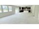 Large, bright living area under construction with unfinished floors and a sliding glass door at 102 Gobbler Dr, Smithfield, NC 27577