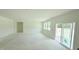 Bright, spacious living area with an unfinished kitchen and sliding door access to the outdoors at 102 Gobbler Dr, Smithfield, NC 27577