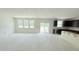Unfinished living space featuring large windows, a sliding door, and an adjacent kitchen area at 102 Gobbler Dr, Smithfield, NC 27577