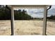 An outdoor view of a field framed by the home's porch pillars at 102 Gobbler Dr, Smithfield, NC 27577