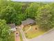 Aerial view of a home with a long driveway and surrounded by lush trees at 1024 Chalmers St, Durham, NC 27707