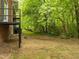 Backyard featuring a deck and grass yard with views of the surrounding trees at 1024 Chalmers St, Durham, NC 27707