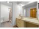 Bathroom featuring a vanity and shower-tub combo with neutral tile at 1024 Chalmers St, Durham, NC 27707