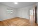 Bedroom featuring hardwood flooring, white walls, and closet space at 1024 Chalmers St, Durham, NC 27707