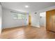 Bedroom with hardwood floors, white walls and trim, and a large window with a wooded view at 1024 Chalmers St, Durham, NC 27707