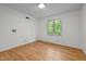 Bright bedroom featuring hardwood floors and a sunlit window view at 1024 Chalmers St, Durham, NC 27707