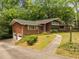 View of the home with an attached garage and front yard with a walkway to the front door at 1024 Chalmers St, Durham, NC 27707
