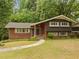 Charming brick home featuring a manicured lawn, inviting walkway, and well-maintained landscaping at 1024 Chalmers St, Durham, NC 27707