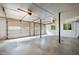 Spacious garage with white walls, concrete floor, and two garage doors at 1024 Chalmers St, Durham, NC 27707