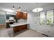 Cozy kitchen featuring wood cabinets with blue details, efficient appliances, and an inviting eat-in space at 1024 Chalmers St, Durham, NC 27707