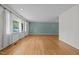 Spacious living room featuring hardwood floors, large windows, and white trim at 1024 Chalmers St, Durham, NC 27707