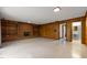 View of a living room with a brick fireplace and built in shelving, along with a glimpse into the bathroom at 1024 Chalmers St, Durham, NC 27707