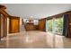 Spacious living area showcasing a staircase, wood paneling, and a view of the kitchen, with a sliding glass door at 1024 Chalmers St, Durham, NC 27707