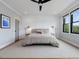 Comfortable bedroom featuring a large bed, hardwood floors, and a ceiling fan at 1027 S Duke St, Durham, NC 27707