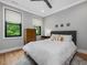 Cozy bedroom with hardwood floors, two windows, and a ceiling fan at 1027 S Duke St, Durham, NC 27707