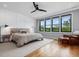 Bright bedroom with many windows, hardwood floors, and a ceiling fan at 1027 S Duke St, Durham, NC 27707