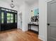 Inviting entryway with hardwood floors, decorative front door, and striking artwork at 1027 S Duke St, Durham, NC 27707