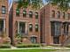 Charming brick townhome featuring a landscaped front yard and inviting entrance staircase at 1027 S Duke St, Durham, NC 27707