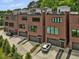 Modern brick townhomes with attached garages, well-manicured landscaping, and sleek architectural details at 1027 S Duke St, Durham, NC 27707