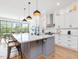 Modern kitchen with a large island, stainless appliances, and elegant finishes at 1027 S Duke St, Durham, NC 27707