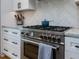 Close-up of a stainless steel oven and cooktop with custom cabinetry and modern finishes at 1027 S Duke St, Durham, NC 27707