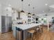 Open-concept kitchen with large island, modern pendant lighting and stainless appliances at 1027 S Duke St, Durham, NC 27707