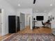 Open-concept living room with wine fridge, workspace, and hardwood floors at 1027 S Duke St, Durham, NC 27707