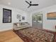 Bright living room with hardwood floors, ceiling fan, sofa, and outdoor access at 1027 S Duke St, Durham, NC 27707