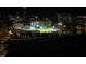 View of Durham Bulls Athletic Park at night, surrounded by city lights and buildings at 1027 S Duke St, Durham, NC 27707