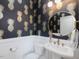 Stylish powder room featuring pineapple wallpaper and white wainscoting at 1027 S Duke St, Durham, NC 27707