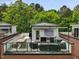 Rooftop deck offering great space with an outdoor kitchen, seating, and views of lush trees at 1027 S Duke St, Durham, NC 27707