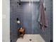 Tiled shower with glass door, built-in bench, and modern fixtures at 1027 S Duke St, Durham, NC 27707