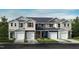Charming townhomes in various colors with attached garages and well-maintained lawns against a bright blue sky at 1029 Mountain Crown St, Durham, NC 27703