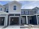 Townhome under construction featuring modern siding and garage with a construction staging area on the lot at 1029 Mountain Crown St, Durham, NC 27703
