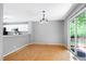 Open dining room with sliding door access to the deck and view into the modern kitchen at 103 Trent Woods Way, Cary, NC 27519