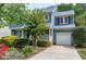 Two-story home showcasing its blue exterior, white trim, and attached one-car garage at 103 Trent Woods Way, Cary, NC 27519