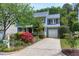 Two-story home featuring blue siding, a white garage door, and a well-manicured lawn at 103 Trent Woods Way, Cary, NC 27519