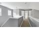 Second floor hallway features gray walls, a light fixture, carpet, and multiple doorways at 103 Trent Woods Way, Cary, NC 27519